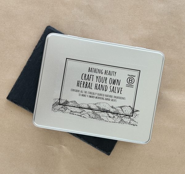 Photo of a Silver metal gift tin with a black hand drawn label, featuring the Clwydian Range