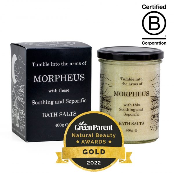 A Black Box and Clear Glass jar with a metal lid, featuring hand drawn illustrations of the Clwydian Range. It Contains Tumble In to The Arms of Morpheus Bath Salts. Also displayed is a Green Paret Magazine Gold Award Logo and b Corp Certified Logo