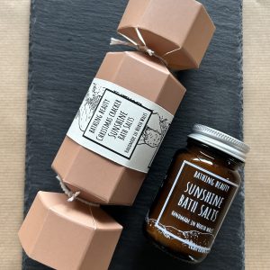 A Christmas Cracker and amber glass apothecary jar of bath salts